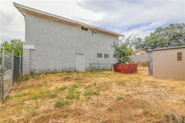 rear view of property with a shed