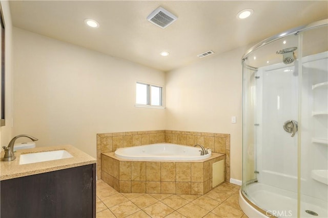 bathroom featuring shower with separate bathtub, vanity, and tile patterned floors