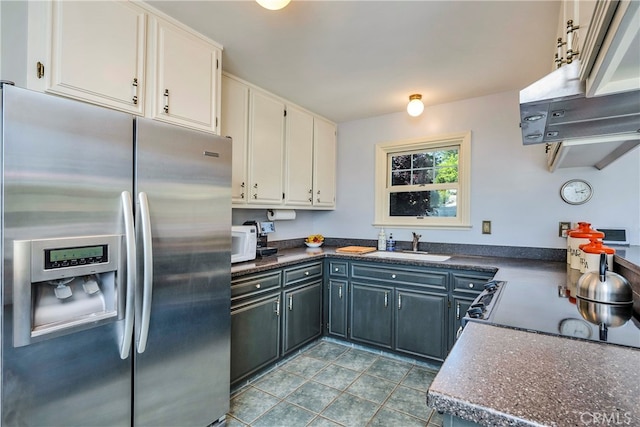 kitchen with white cabinetry, stainless steel fridge, tile floors, gray cabinets, and sink