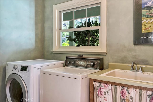 laundry area with washer and clothes dryer and sink