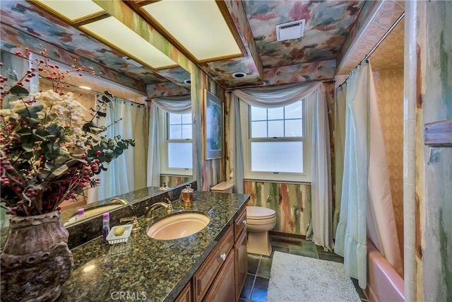 full bathroom featuring tile flooring, oversized vanity, a wealth of natural light, and toilet