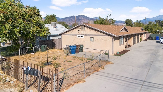 view of home's exterior with a mountain view and central AC unit