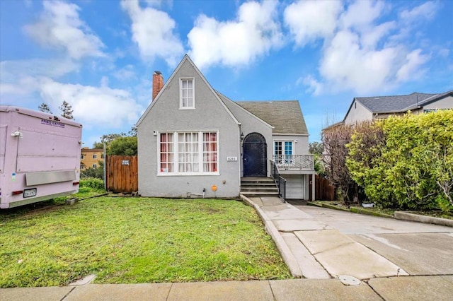 view of front of home with a garage and a front lawn