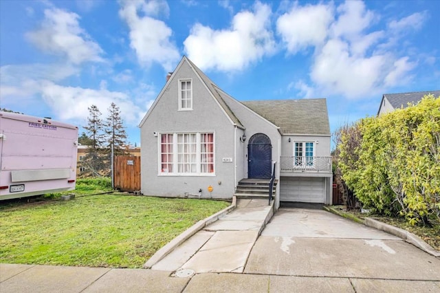 view of front of property with a garage and a front lawn