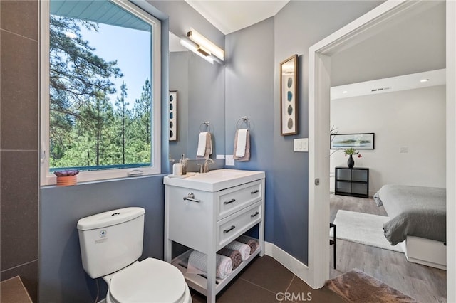 bathroom featuring hardwood / wood-style floors, vanity, and toilet