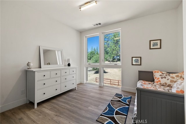 bedroom featuring light hardwood / wood-style floors and multiple windows