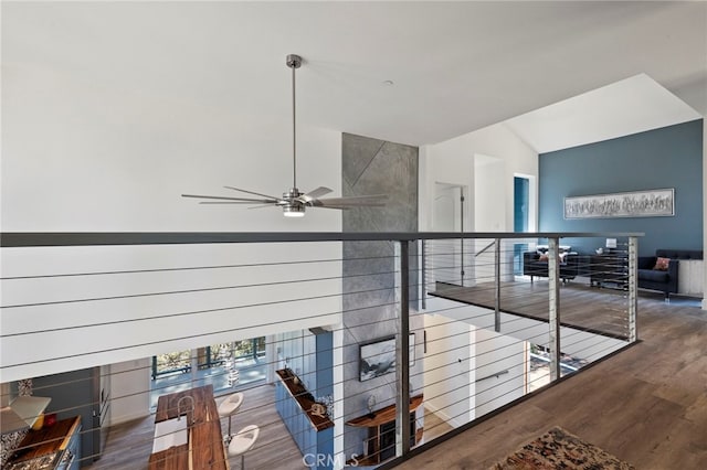 corridor with dark hardwood / wood-style flooring and lofted ceiling