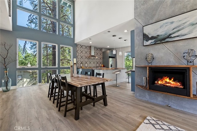 19574 Butler Way, Groveland, CA 95321 - dining space with wood finished floors, a warm lit fireplace, a high ceiling, and recessed lighting