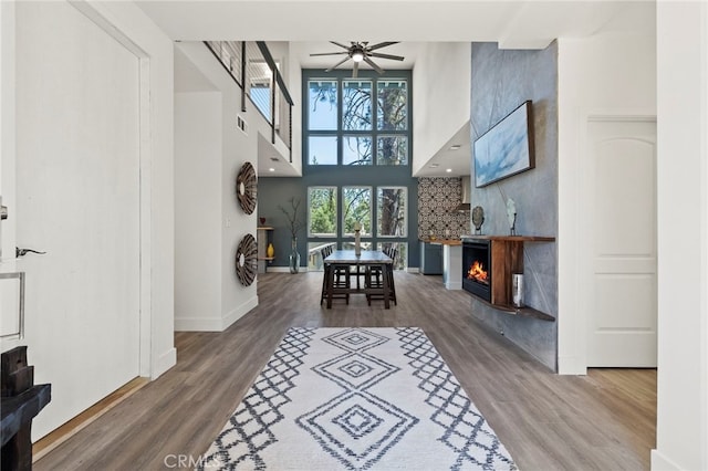 19574 Butler Way, Groveland, CA 95321 - entryway featuring a warm lit fireplace, a ceiling fan, wood finished floors, and a towering ceiling