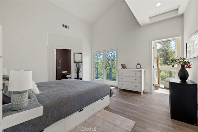 19574 Butler Way, Groveland, CA 95321 - bedroom featuring wood finished floors, high vaulted ceiling, attic access, and ensuite bath