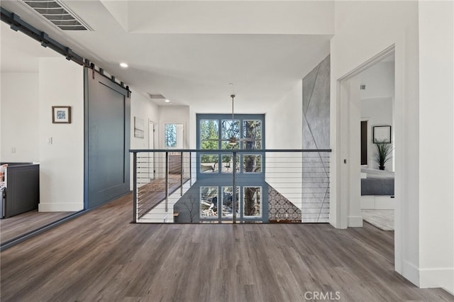 19574 Butler Way, Groveland, CA 95321 - unfurnished room featuring a barn door and wood finished floors