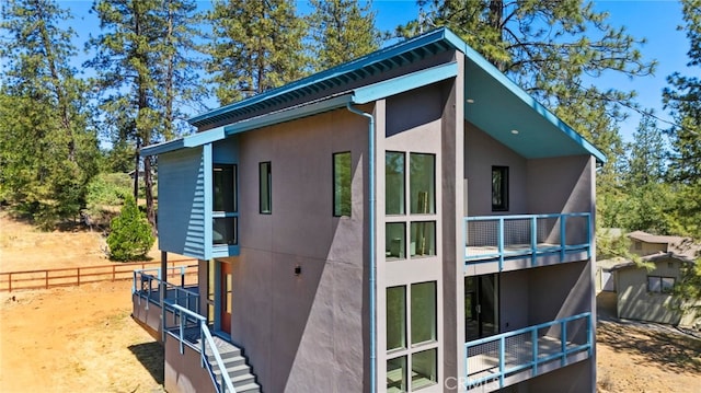 19574 Butler Way, Groveland, CA 95321 - view of side of home featuring stucco siding and a balcony