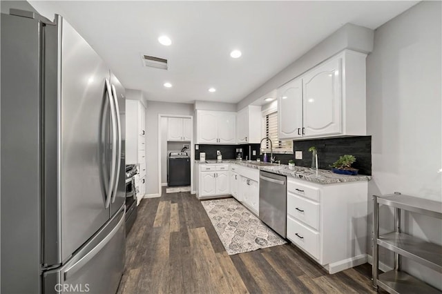 7410 Frontera Ave, Yucca Valley, CA 92284 - kitchen with sink, dark hardwood / wood-style floors, stainless steel appliances, decorative backsplash, and white cabinets
