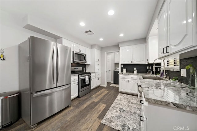 7410 Frontera Ave, Yucca Valley, CA 92284 - kitchen featuring sink, dark wood-type flooring, appliances with stainless steel finishes, light stone countertops, and white cabinets