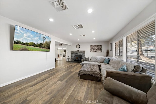 7410 Frontera Ave, Yucca Valley, CA 92284 - living room featuring wood-type flooring and a stone fireplace