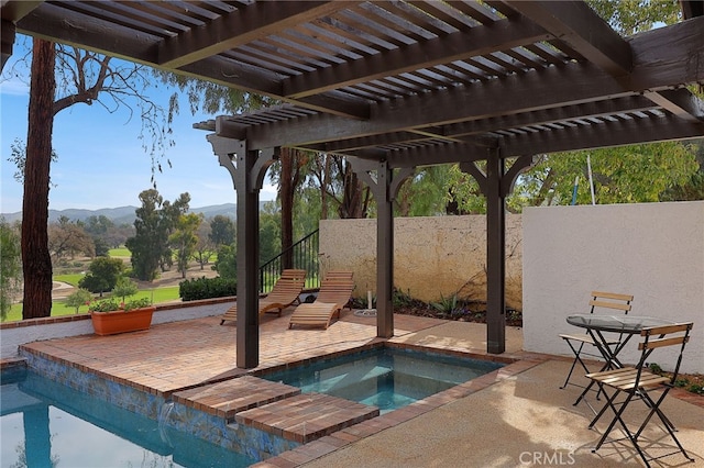 view of swimming pool featuring an in ground hot tub, a mountain view, a patio, and a pergola