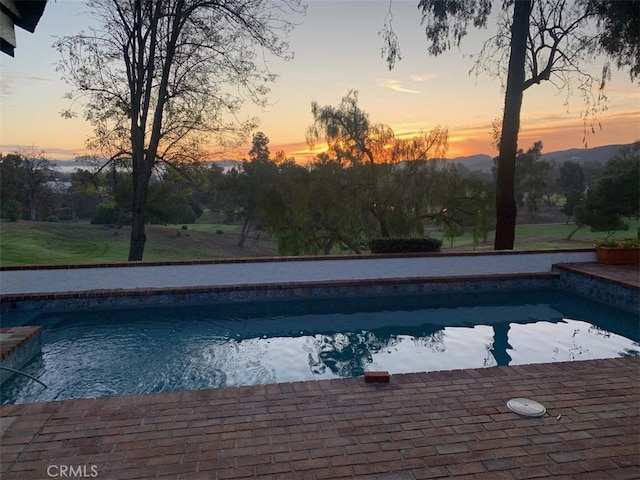 view of pool at dusk