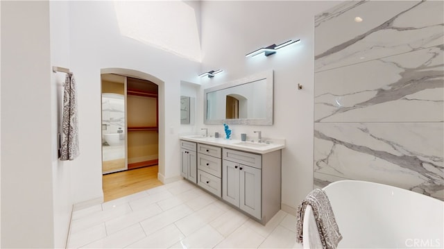 bathroom with tile patterned floors, vanity, and a bathtub