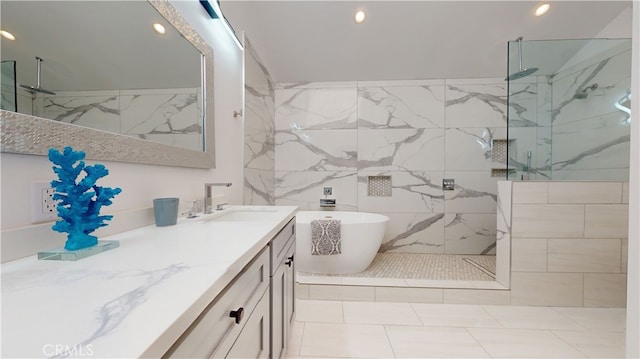 bathroom featuring vanity, tiled shower, and tile patterned floors