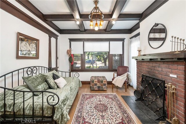 living area with coffered ceiling, a brick fireplace, dark hardwood / wood-style flooring, beamed ceiling, and a chandelier