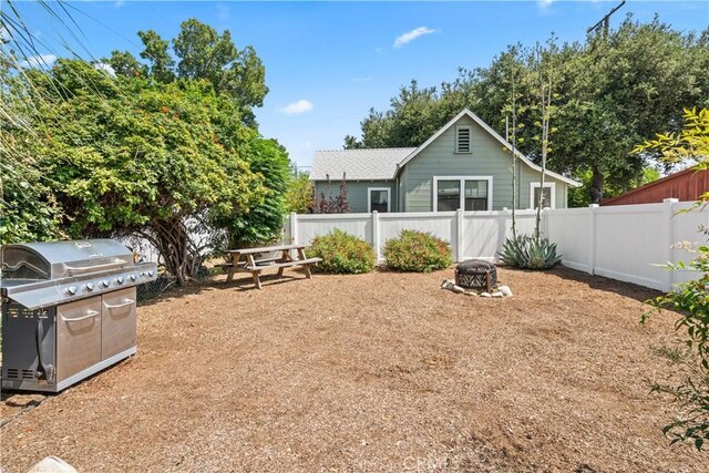 view of yard with an outdoor fire pit