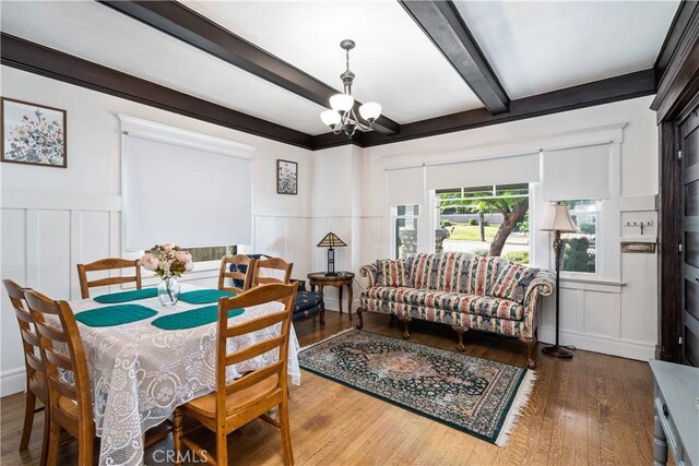 dining area featuring beam ceiling, a chandelier, and dark wood-type flooring