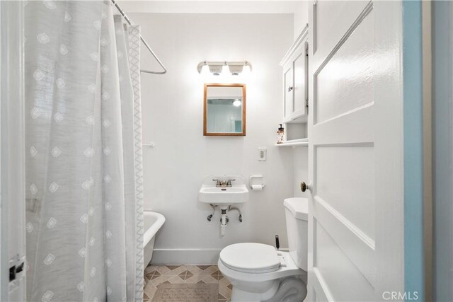 bathroom with a shower with curtain and toilet