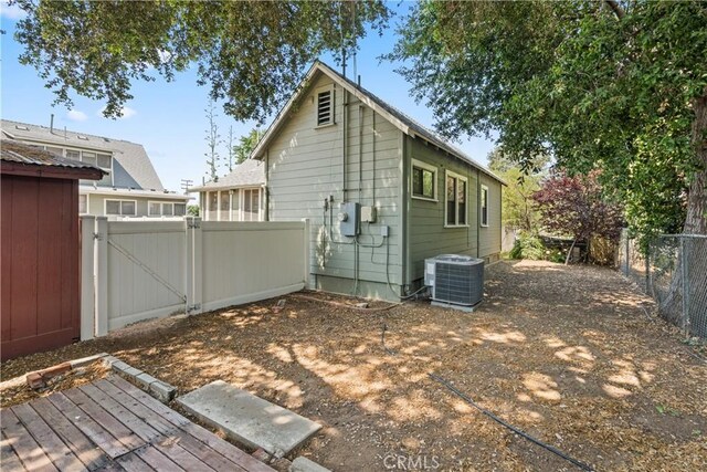 back of property featuring central AC unit