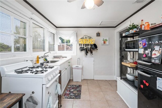 kitchen with white cabinets, sink, a wealth of natural light, and gas range gas stove