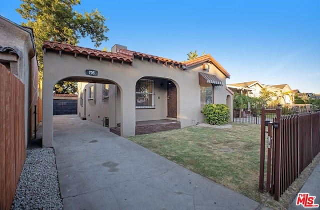 mediterranean / spanish-style home with a front yard