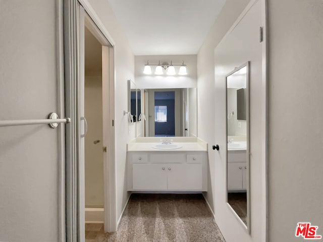 bathroom featuring vanity and an enclosed shower