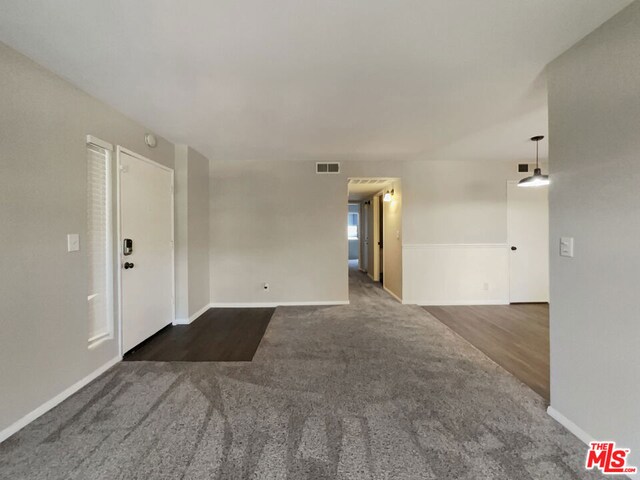 unfurnished room featuring dark hardwood / wood-style flooring