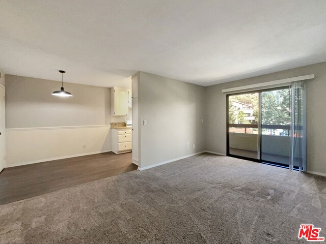 spare room with dark hardwood / wood-style floors