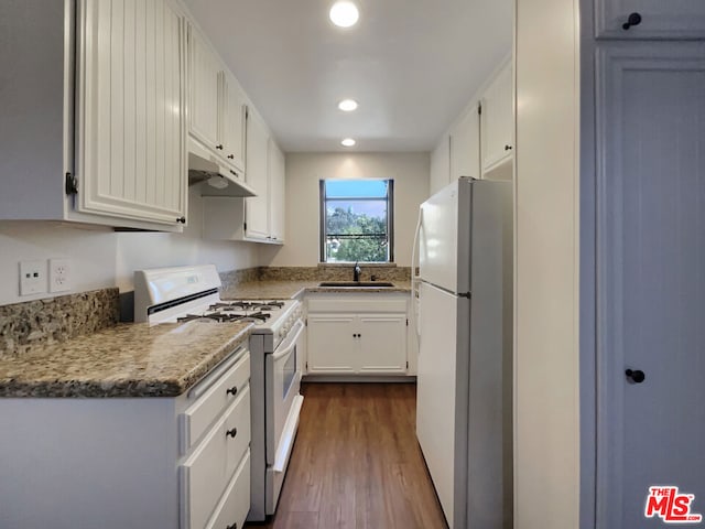 kitchen featuring dark hardwood / wood-style flooring, light stone counters, white appliances, sink, and white cabinets