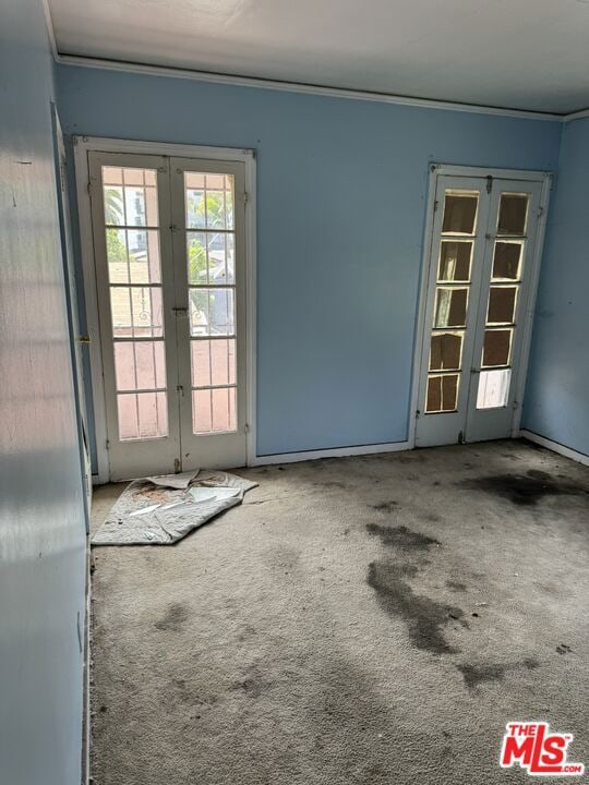 carpeted spare room with french doors