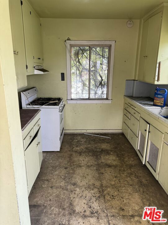 kitchen featuring white gas range oven and extractor fan