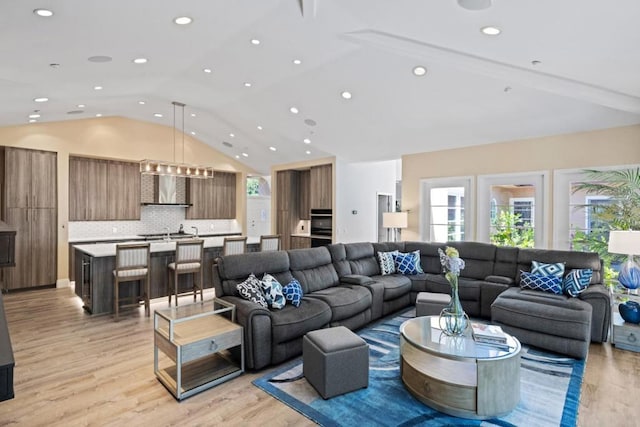 living room featuring light hardwood / wood-style floors and lofted ceiling