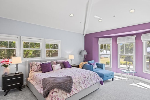 carpeted bedroom featuring vaulted ceiling with beams