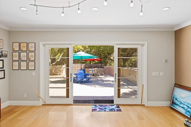 doorway featuring crown molding, french doors, and light hardwood / wood-style floors