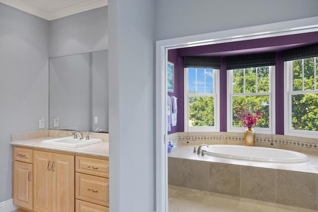 bathroom featuring vanity, tiled bath, and ornamental molding