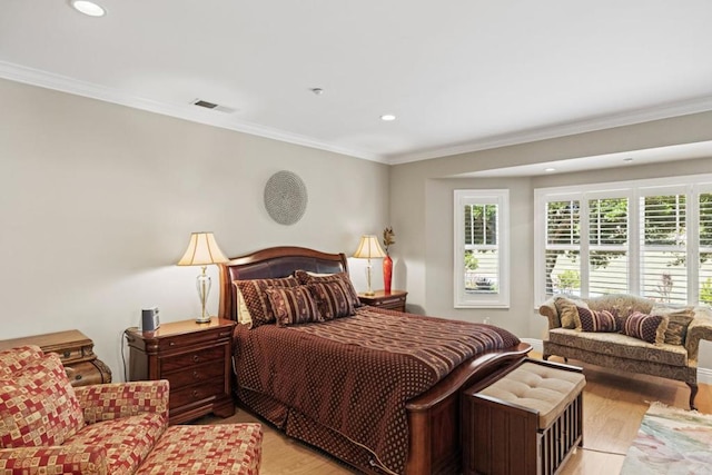 bedroom with light wood-type flooring and crown molding