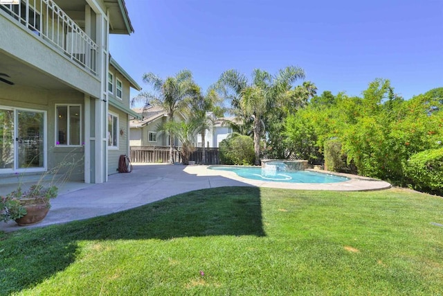 view of yard featuring a balcony and a patio