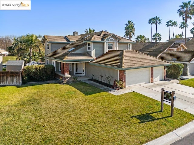 view of property with a front lawn and a garage