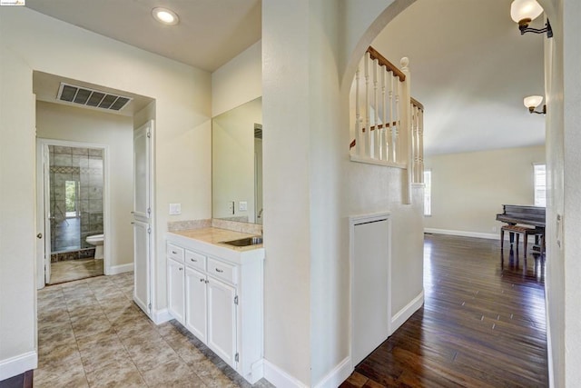 bathroom with hardwood / wood-style floors, toilet, and vanity