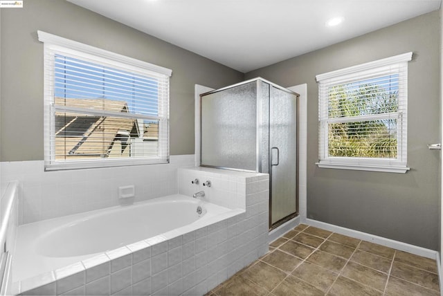 bathroom with separate shower and tub and tile patterned floors