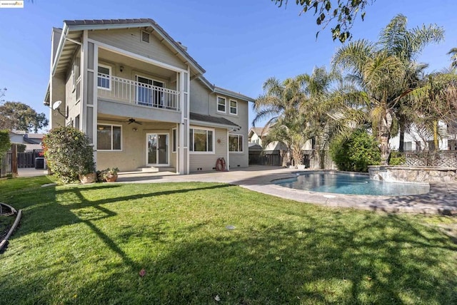 rear view of house with a yard, a patio area, and a balcony