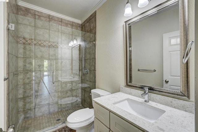 bathroom featuring toilet, vanity, an enclosed shower, and crown molding