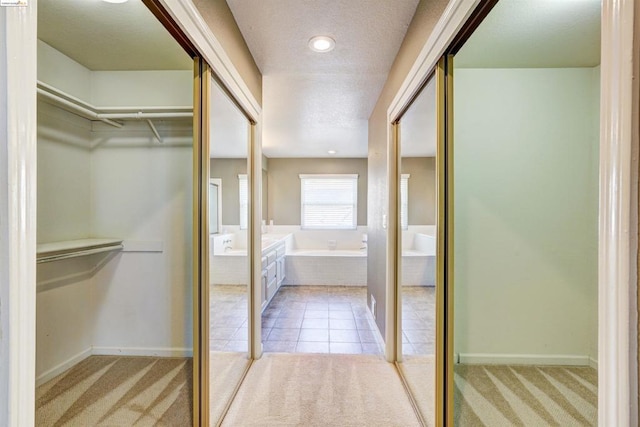 walk in closet featuring light carpet