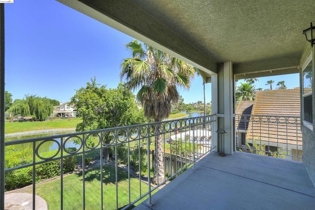 balcony featuring a water view