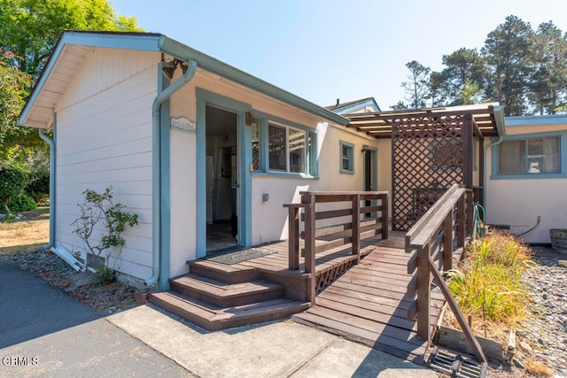 rear view of house featuring a deck